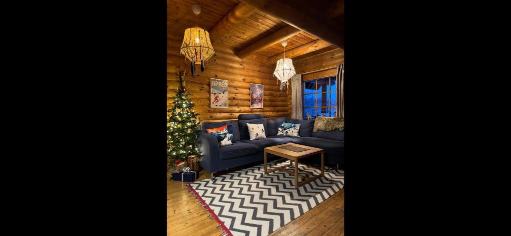 a living room with a christmas tree and a blue couch at Kelgumäe in Otepää