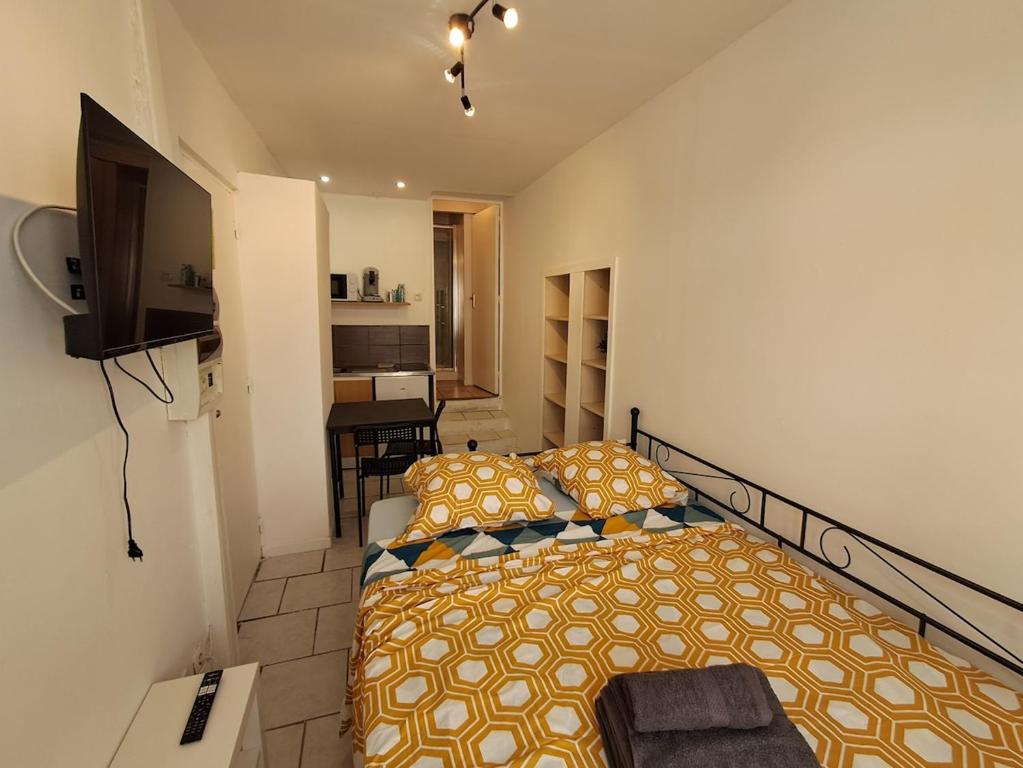 une chambre avec un lit et une télévision dans l'établissement Budgetbnb 180 centre ville, à Toulon