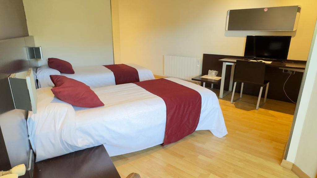 Postel nebo postele na pokoji v ubytování Hotel Bruc
