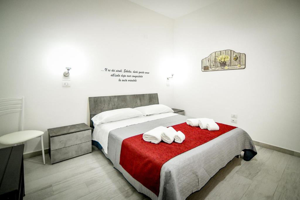 Ένα ή περισσότερα κρεβάτια σε δωμάτιο στο Sikania Rooms