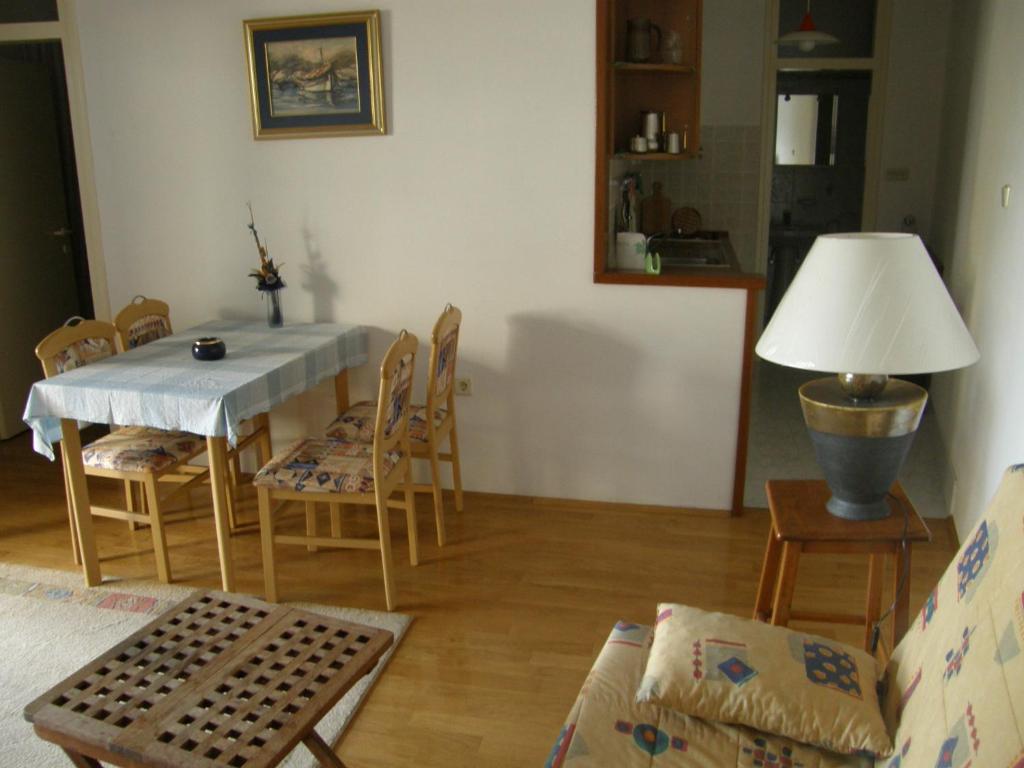 a living room with a table and chairs at Marina Apartment in Crikvenica