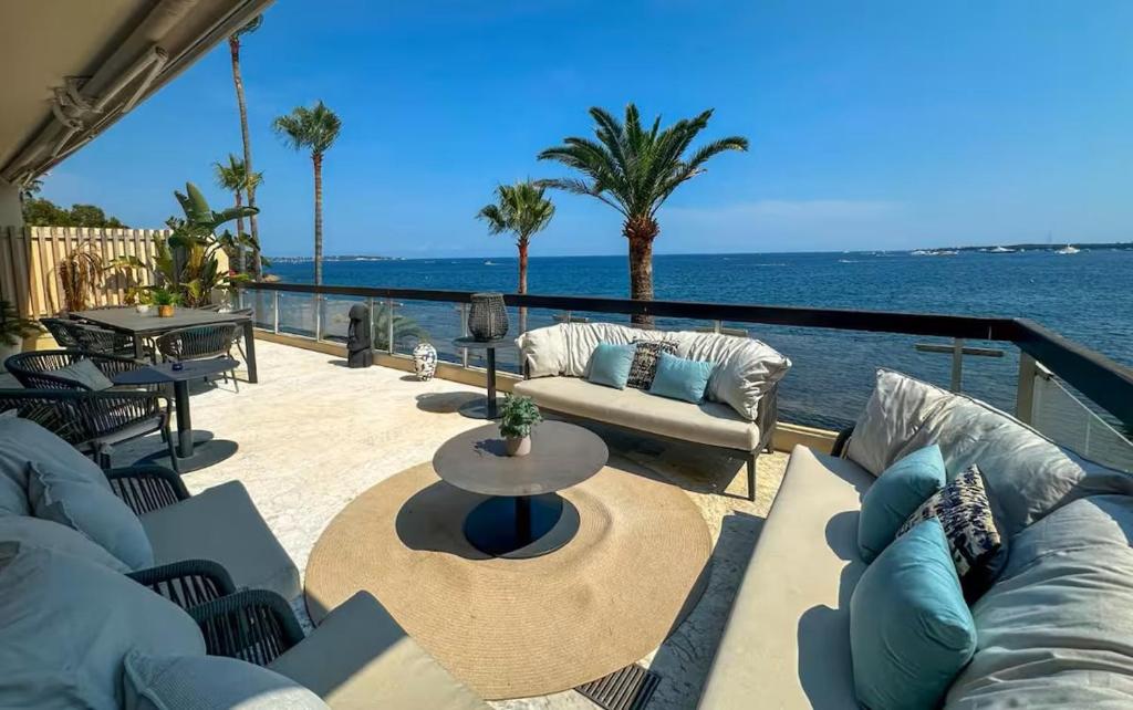 d'une terrasse avec des canapés et une vue sur l'eau. dans l'établissement ADR2 - Appartement de 4 pièces avec vue mer, à Cannes