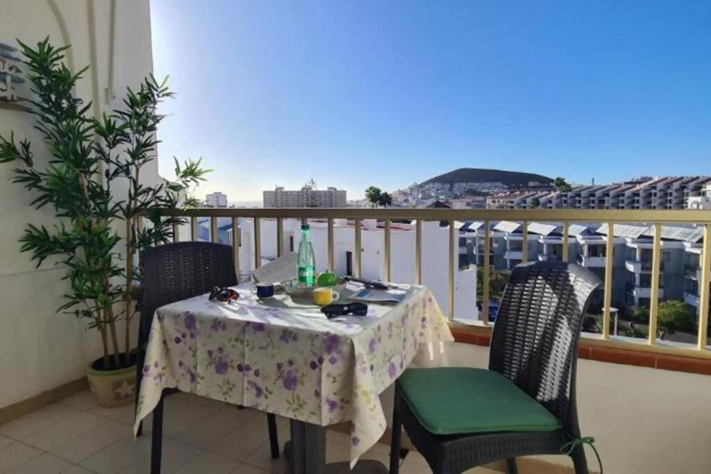 a table and chairs on a balcony with a view at Joy & Friends 1 in Los Cristianos