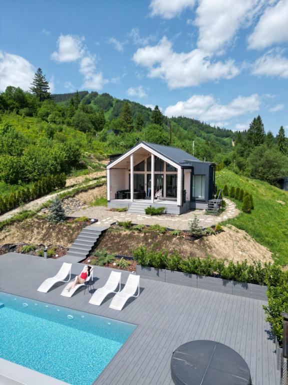 a house on a hill with a swimming pool at Rest Hub in Slavske