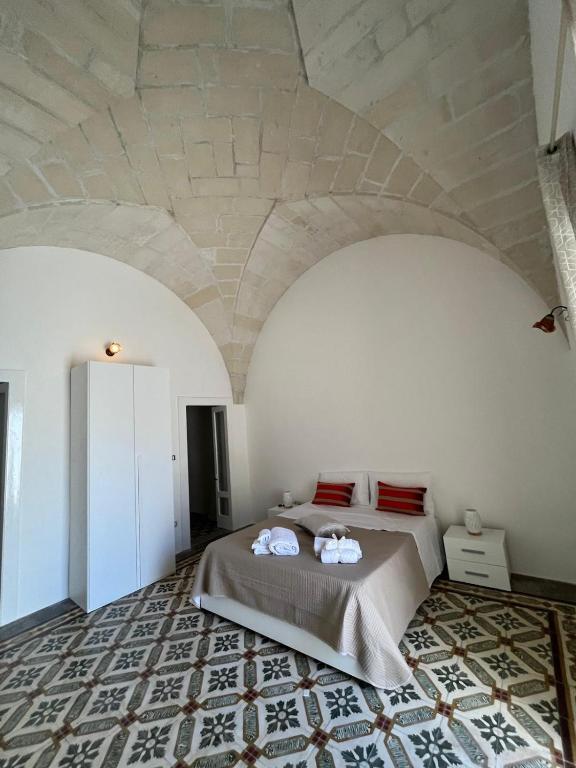 a bedroom with a bed and a stone ceiling at Gioem in Botrugno