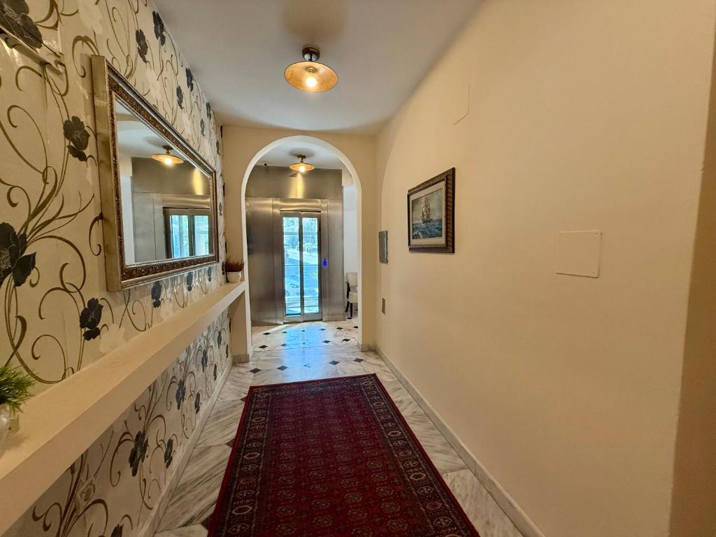 a hallway with a mirror and a red rug at Hotel Villa Perla Di Mare in Budva