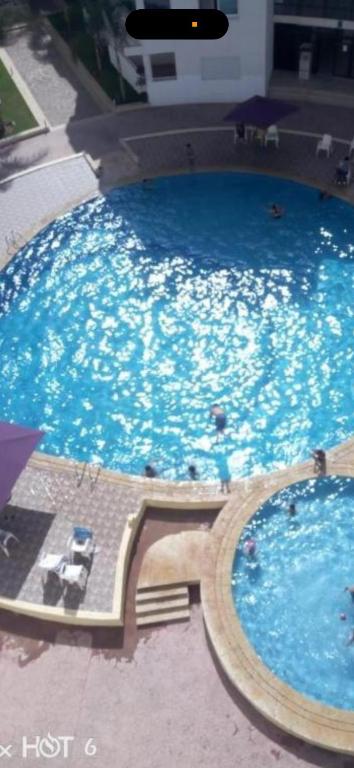 a large pool of water with people in it at Jnane dalia in Bouznika