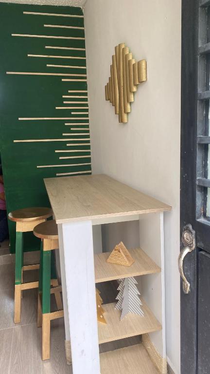 a table and stool in a room with a chalkboard at BORA - Apto 101Tu espacio fuera de casa in Ibagué