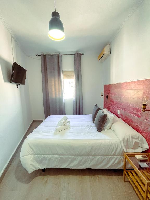 Postel nebo postele na pokoji v ubytování Hostal El Pinar