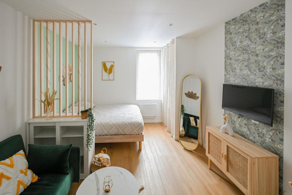 - un petit salon avec un canapé et un lit dans l'établissement Serena, au Havre