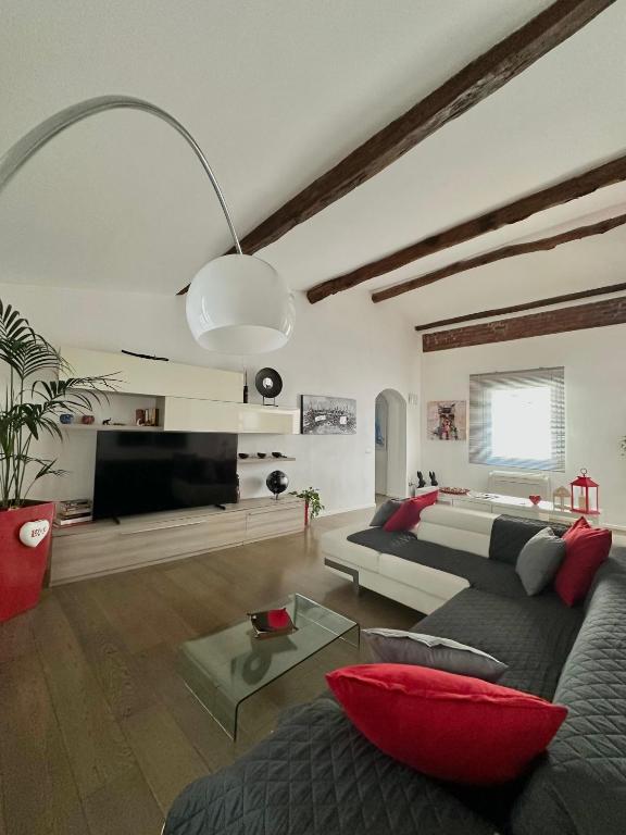 a large living room with a couch and a tv at Ca' del Grillo in La Spezia