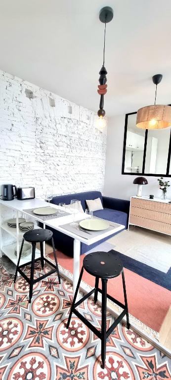 - un salon avec une table et deux tabourets dans l'établissement Grand studio avec terrasse - Gare - Metro - Wifi, à Toulouse