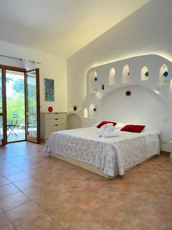 Postel nebo postele na pokoji v ubytování Green Hotel "I Mandorli di Dommos"