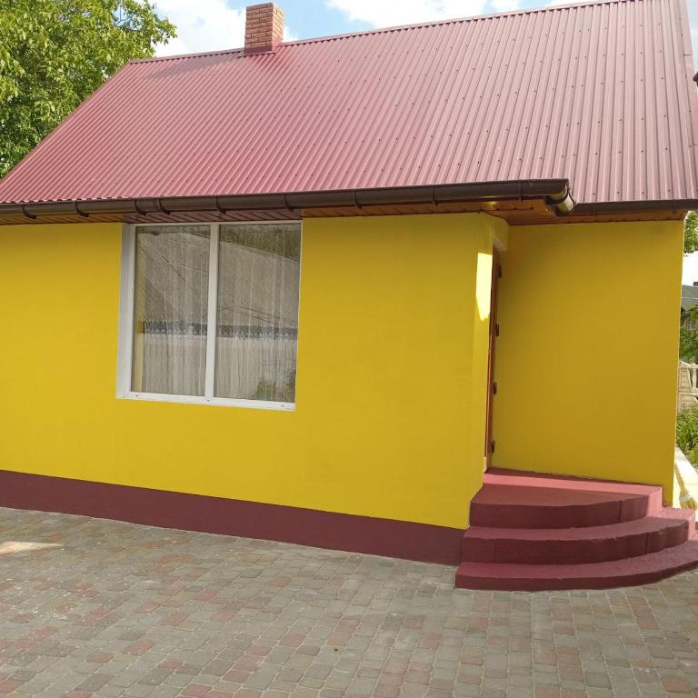 a yellow house with a red roof at Ципель 1 in Szack