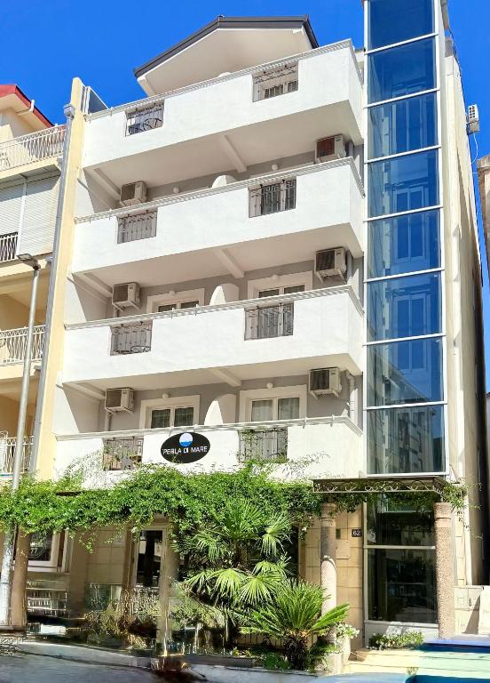 a white building with trees in front of it at Hotel Villa Perla Di Mare in Budva
