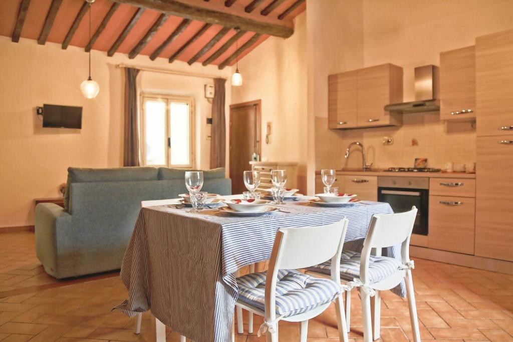 una cucina con tavolo e sedie con un tavolo e un divano di Parcheggio gratuito vicino alla Torre di Pisa a Pisa
