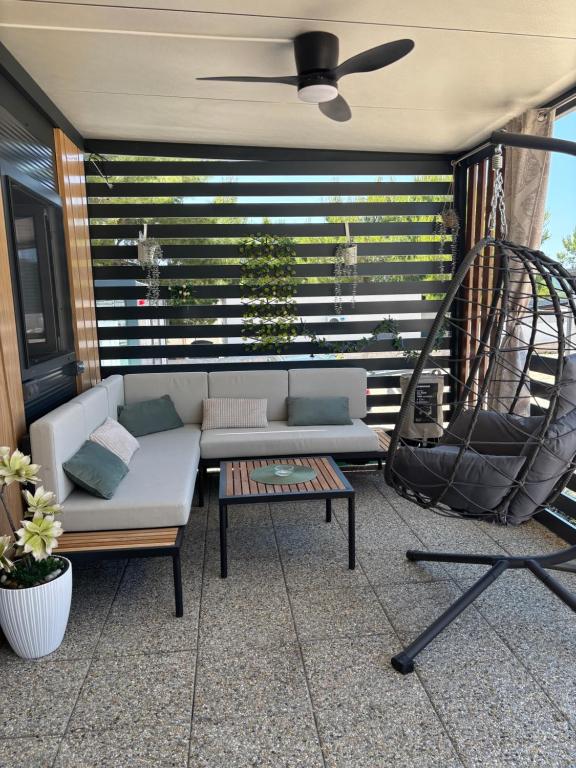 a patio with a couch and a table at Vilma Rosa in Drage