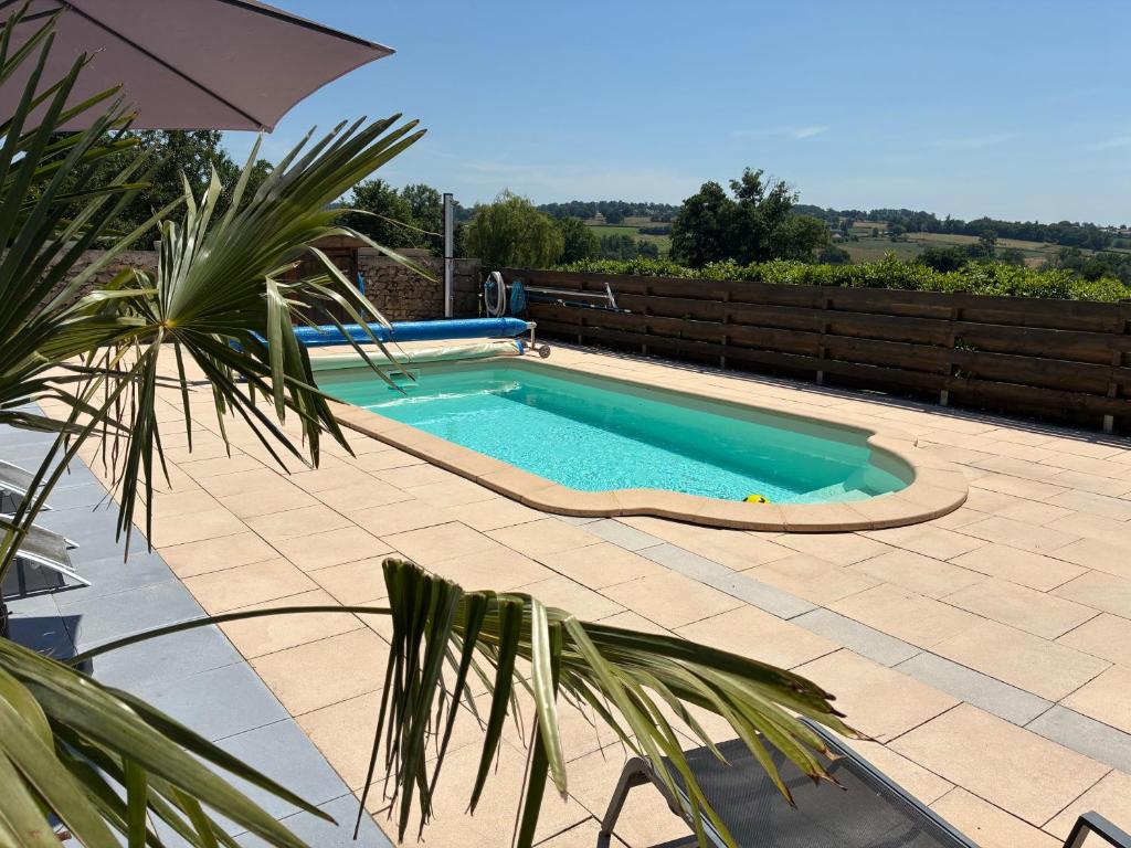 a small swimming pool on a patio with a fence at Gîte au Bon Accueil Therence in Sainte-Thérence