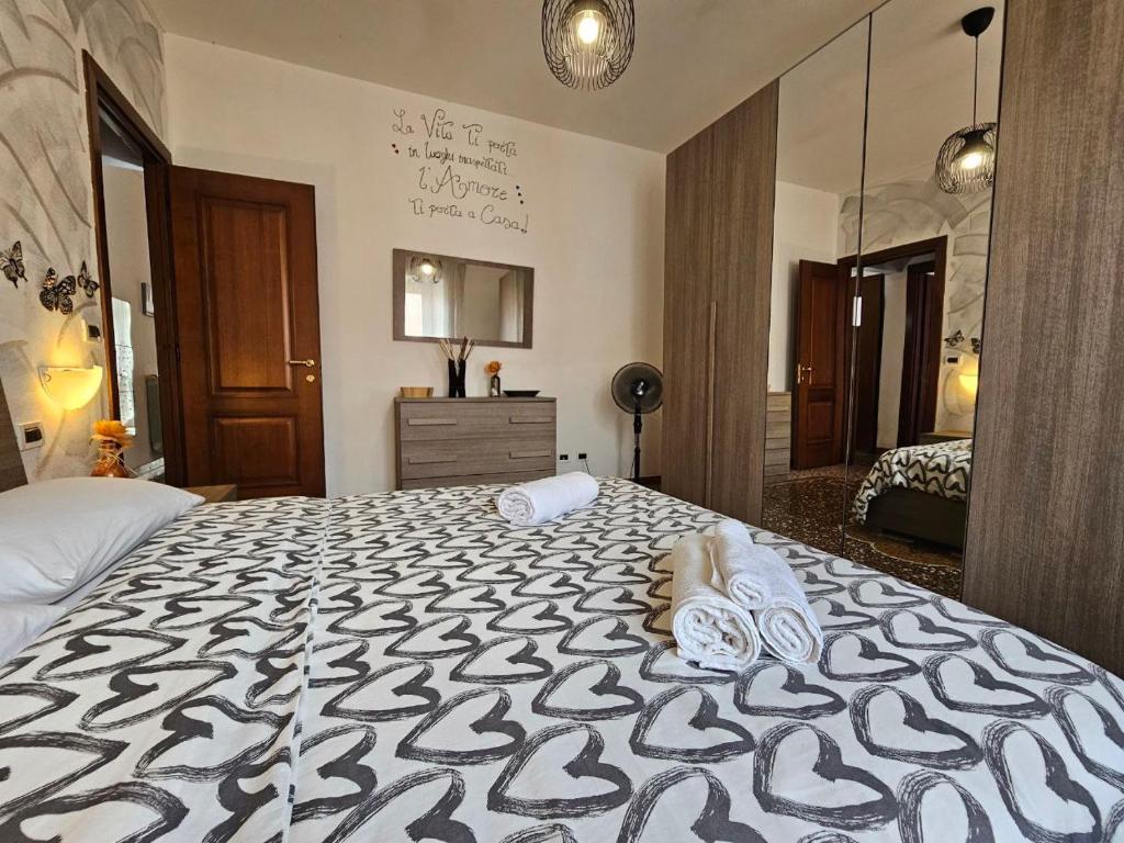 a bedroom with a large bed with a black and white blanket at Casa Mara in Savona