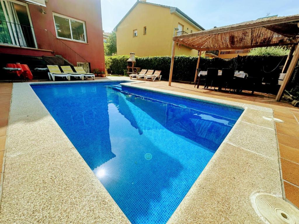 a swimming pool with blue water in a house at Holiday Home La Victoria by Interhome in Palafrugell