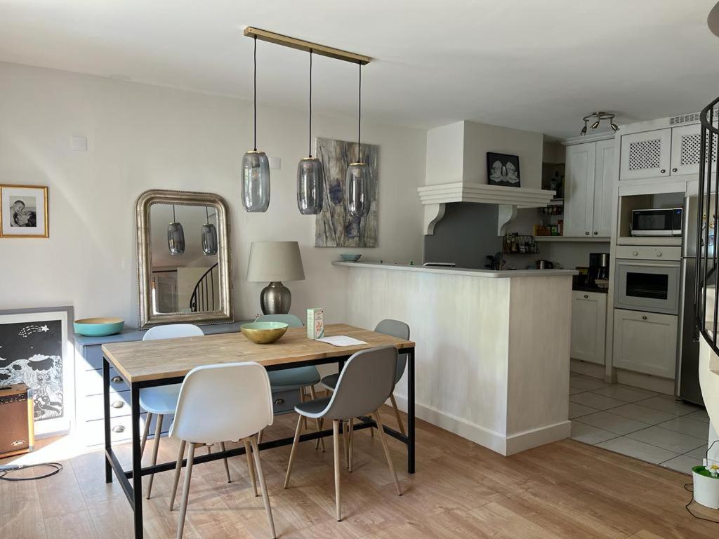 une cuisine et une salle à manger avec une table et des chaises dans l'établissement Maison village provençal, à Éguilles