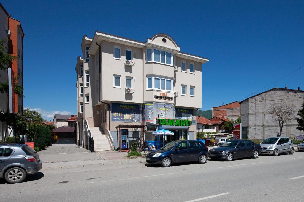 a tall building on a city street with parked cars at Villa Miranda NG in Ohrid