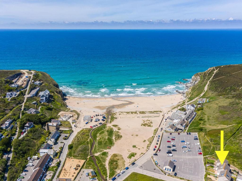 an aerial view of a beach and the ocean at Kippy Cottage in Porthtowan