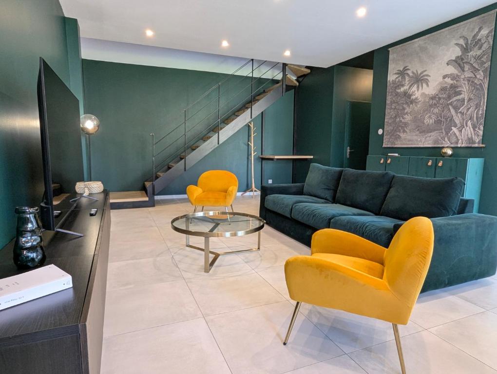 - un salon avec un canapé bleu et des fauteuils orange dans l'établissement ColorChic 3 étoiles - Parking Privé Terrasse Clim - 120m2 Plein centre, à Mèze