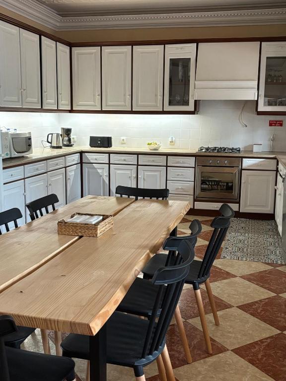a large kitchen with a wooden table and chairs at Ocean House in Ferrel
