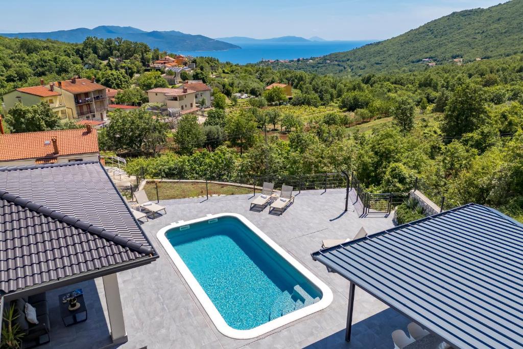 an image of a swimming pool on top of a house at Villa Mantis in Mošćenička Draga