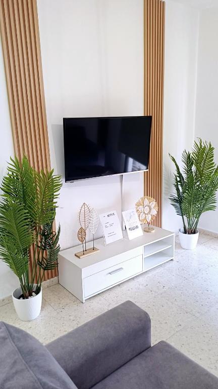a living room with a tv on a white cabinet at Modern 2bd appartment near mall- Internet 1Gbps in Paphos