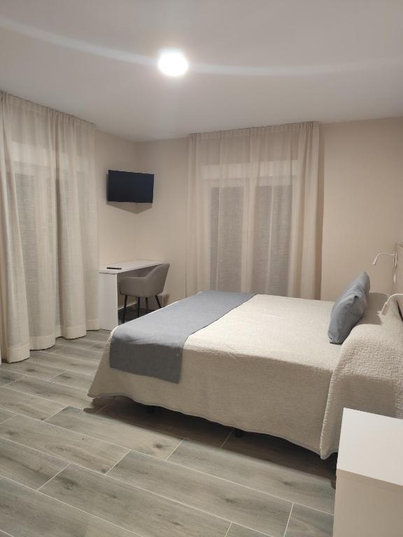 Postel nebo postele na pokoji v ubytování Hotel Querol