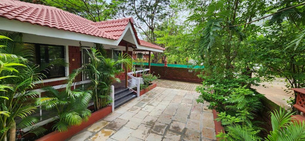 a house with a pathway leading to the front of it at Gulmohar Villa tamhini ghat, Kolad Rafting 