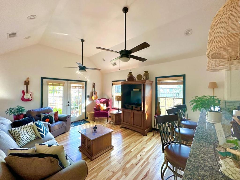 a living room with a couch and a tv at HOUSE OF ROCK - DOWNTOWN, RUPP ARENA, KEENELAND, HORSE PARK in Lexington