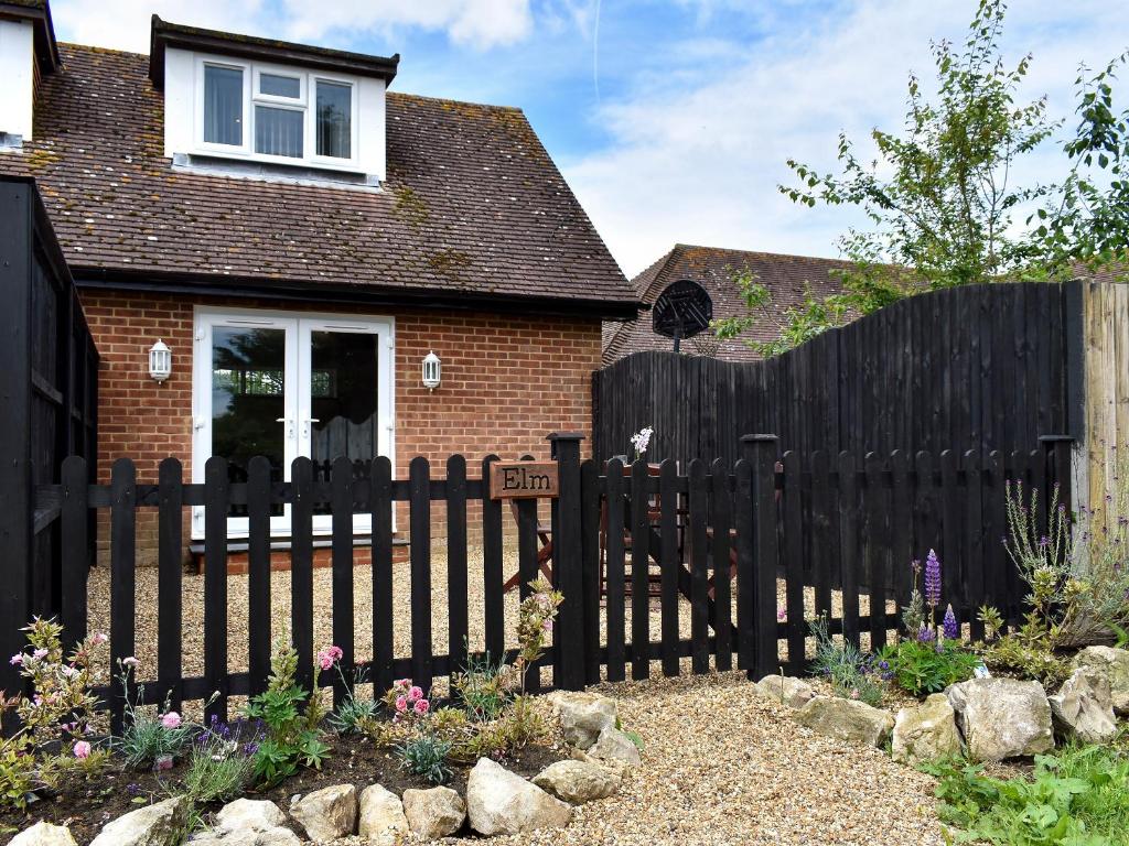 a black fence in front of a house at Elm - Uk11991 in Greenhill