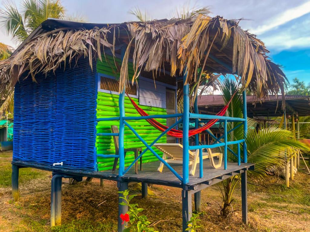 a shack with a thatched roof and a hammock at No exist3 in Playa Juan de Dios