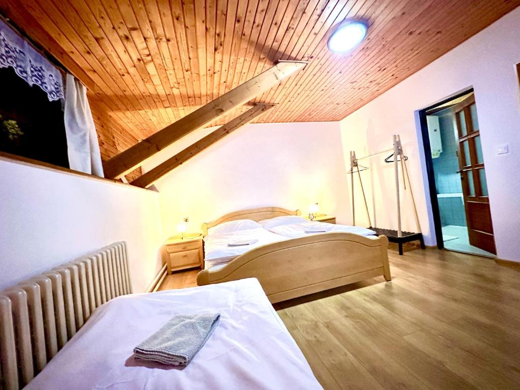 A bed or beds in a room at Penzión Hrubjak