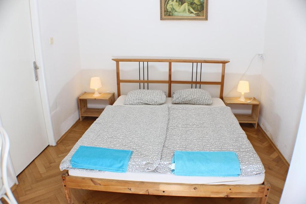 a bedroom with a bed with blue pillows on it at Prague-1 Hostel in Prague