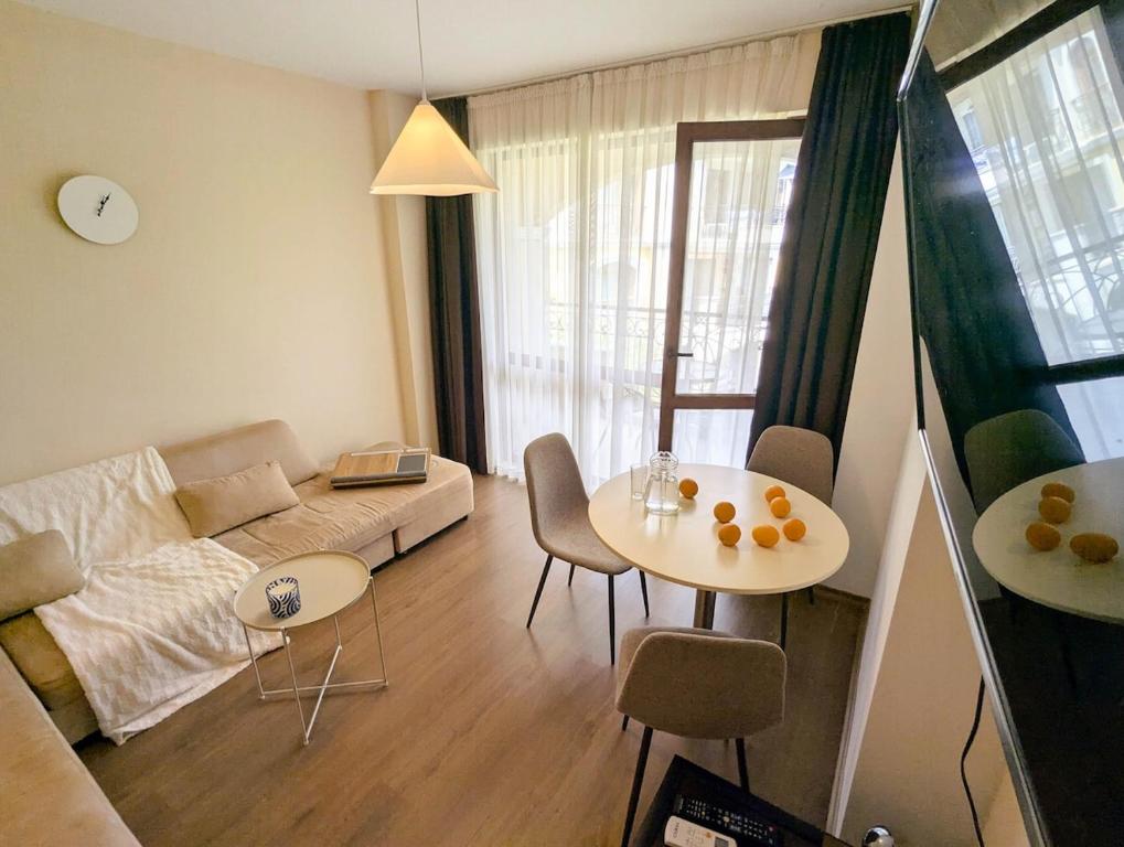 a living room with a couch and a table at Cozy apartment on Sunny Beach in Sunny Beach
