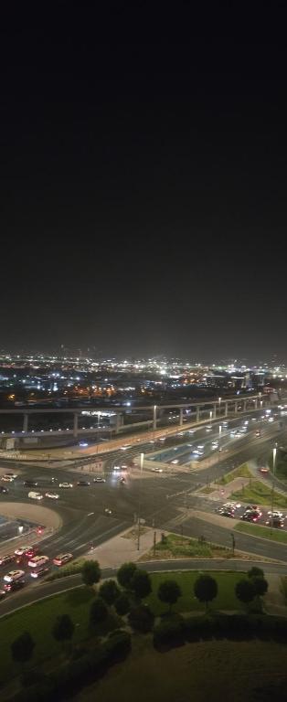 a city at night with cars on a highway at sara apartment in Dubai
