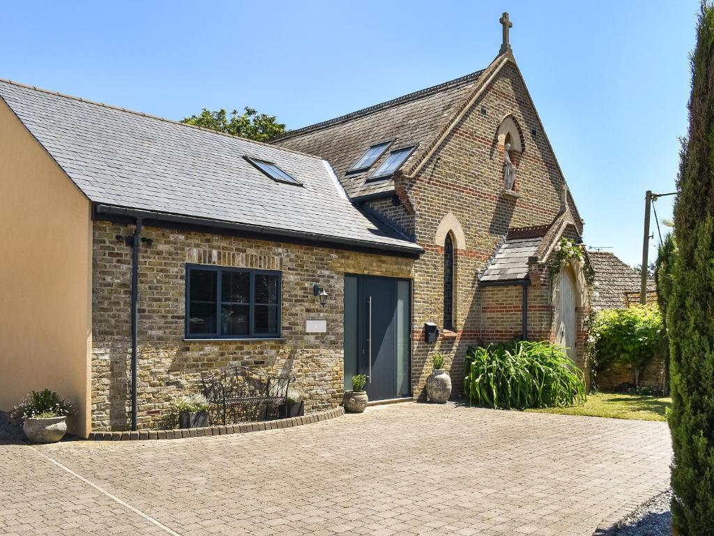 a brick church with a driveway in front of it at St Mildred's Church in Ramsgate