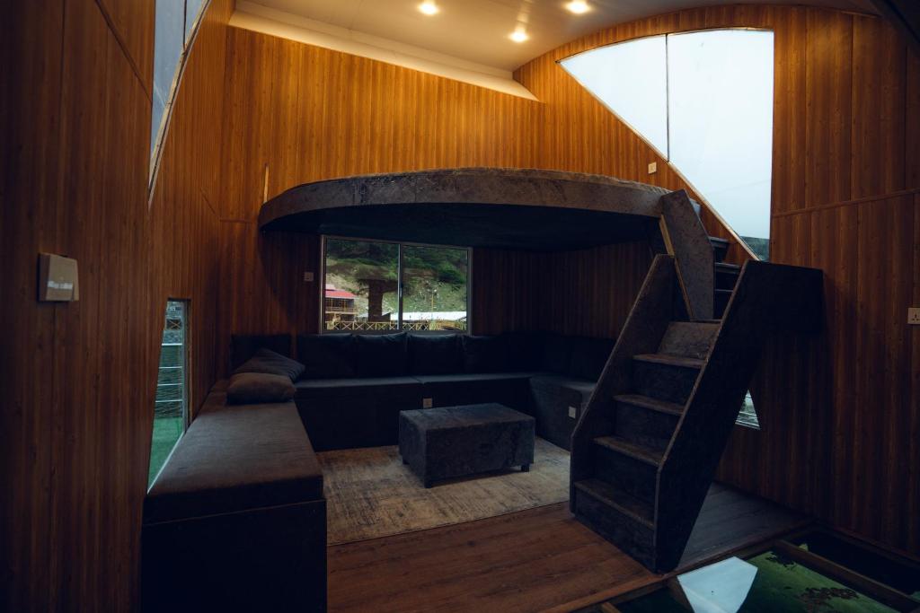 a living room with a couch and a spiral staircase at Azure Lagoon Resort 