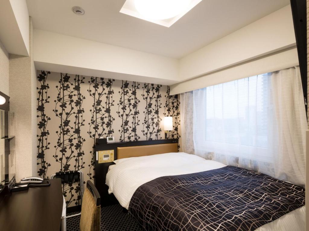 Postel nebo postele na pokoji v ubytování APA Hotel Kanda Ekimae