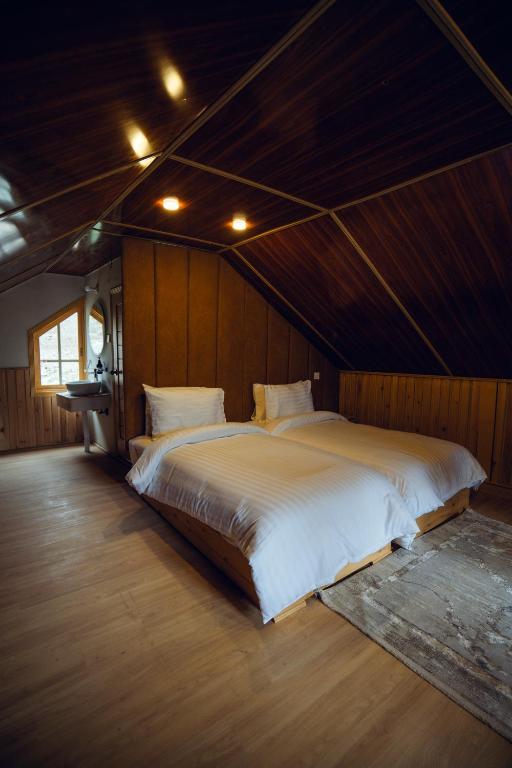 a bedroom with a large white bed in a room at Azure Lagoon Resort 
