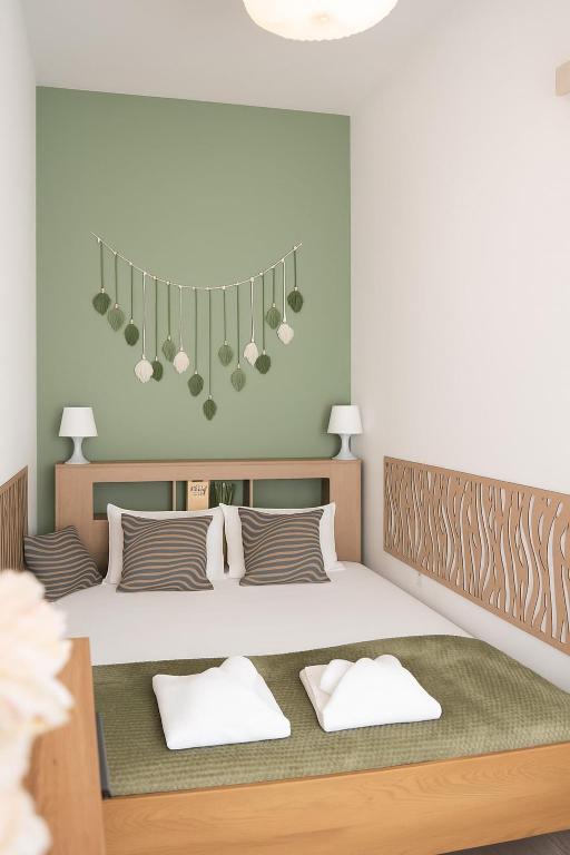 a bedroom with a large bed with two pillows at Cosy Hideaway near Kiserdo in Balatonfüred