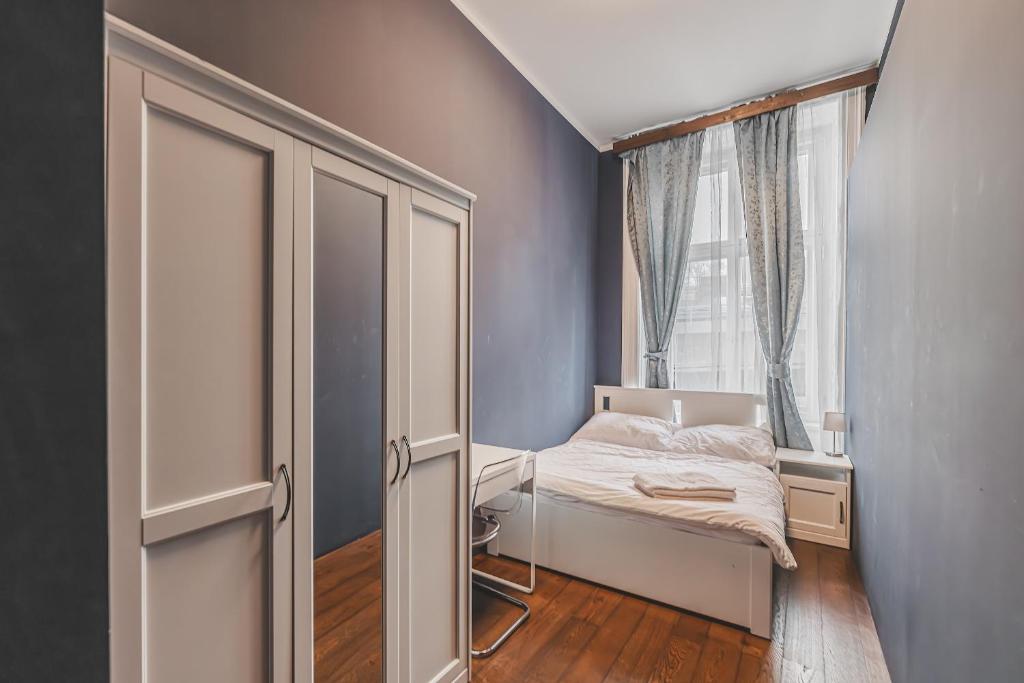 a small bedroom with a bed and a window at Heart of Prague Lodgings 3 in Prague