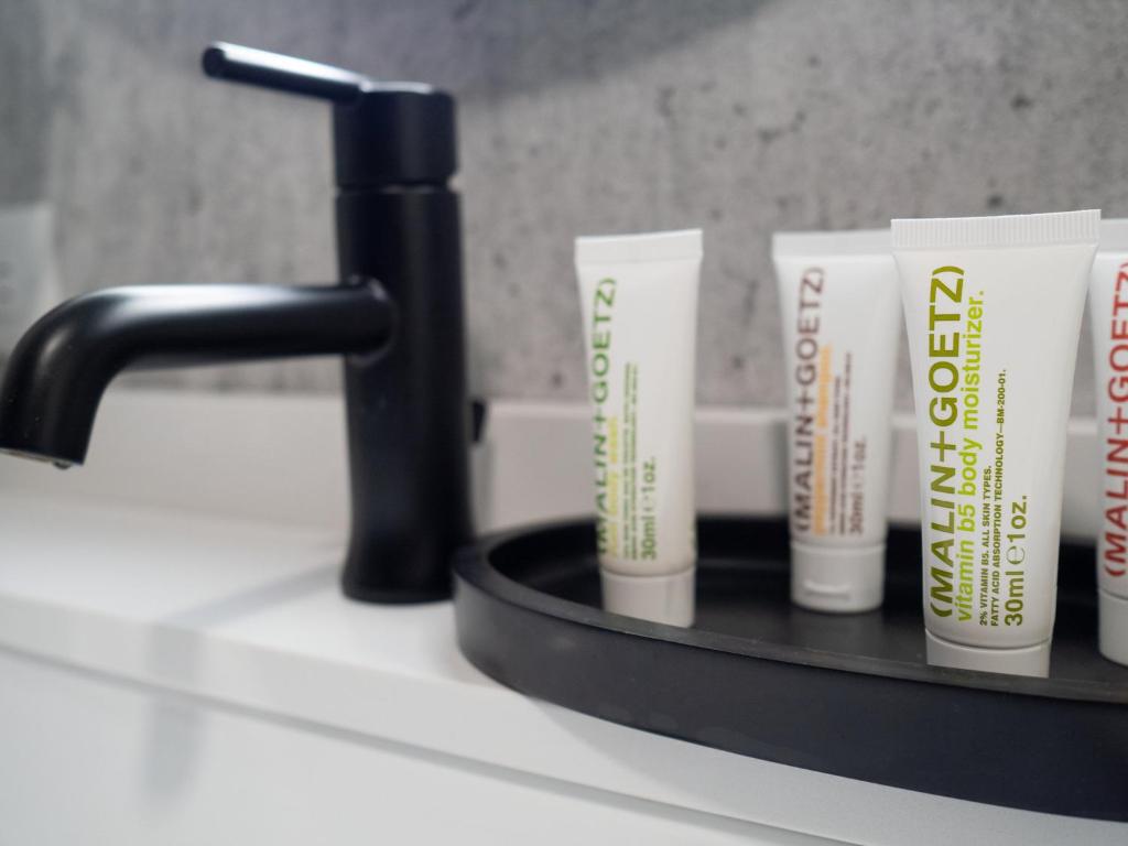 a shelf with four toothbrushes on a bathroom counter at Hotel Indigo Chattanooga - Downtown by IHG in Chattanooga