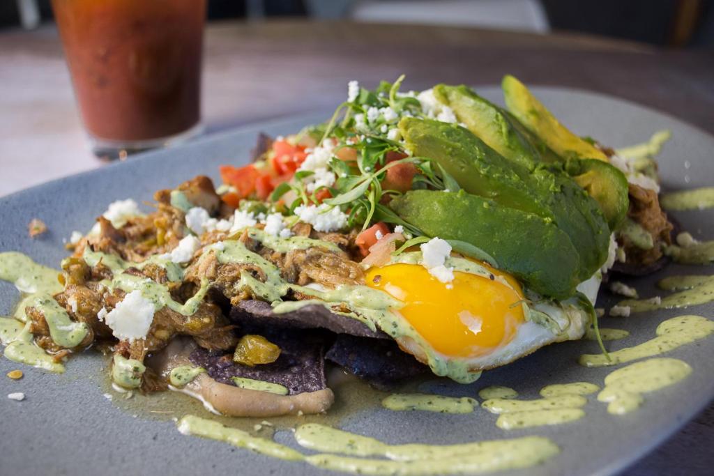 a plate of food with an egg and a salad at Hotel Indigo Chattanooga - Downtown by IHG in Chattanooga