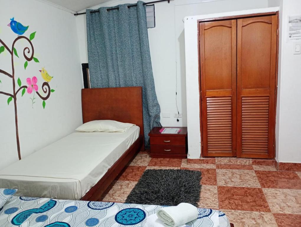 Postel nebo postele na pokoji v ubytování Hostal Casa Yare