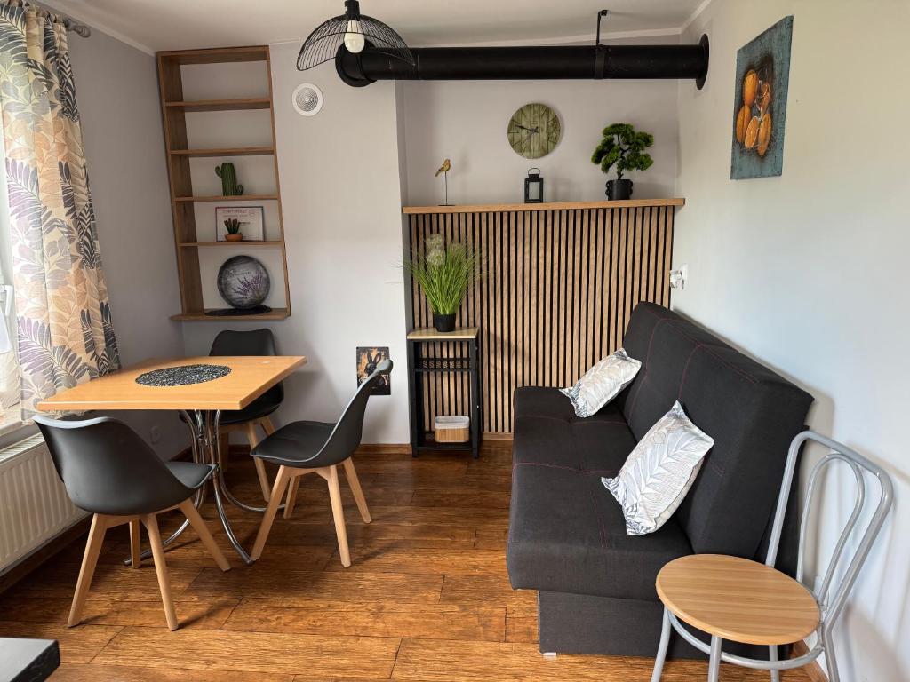 a living room with a couch and a table at Domek M5 w centrum Wiela in Wiele